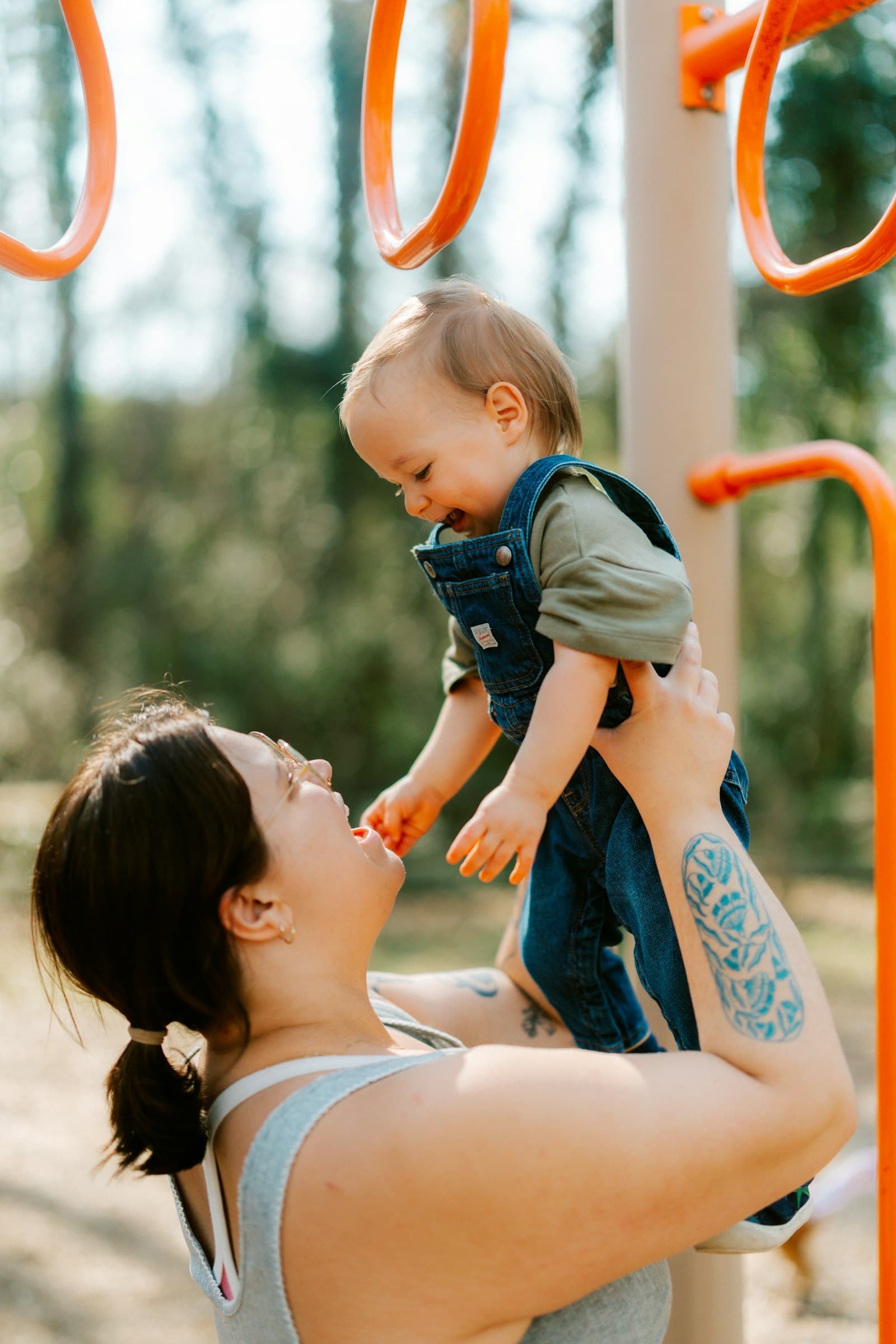 Parent holding child at a playground