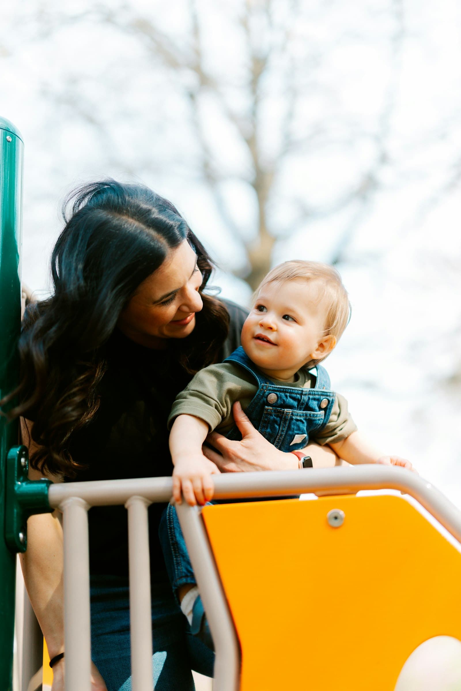 Mother and child enjoying a playground slide